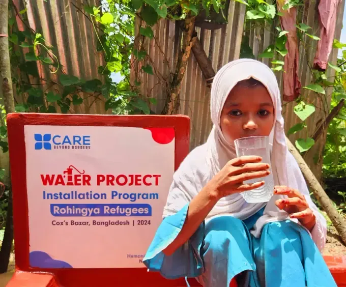 A girl drinks clean water from a CBB water pump