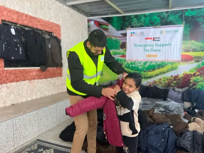 A CBB volunteer comforts a young child after a disaster