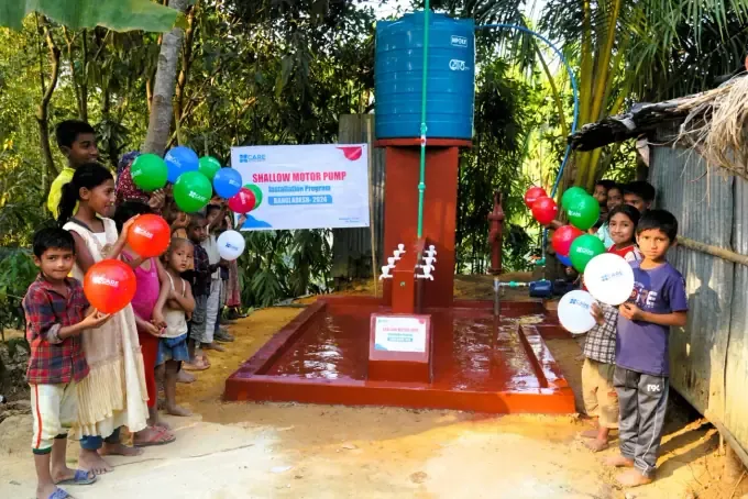 Families gather at a CBB clean-water pump