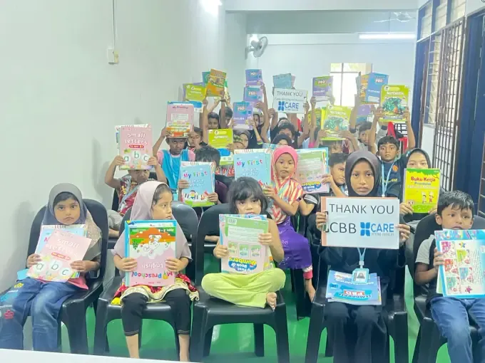 Students with CBB school kits and a thank-you banner