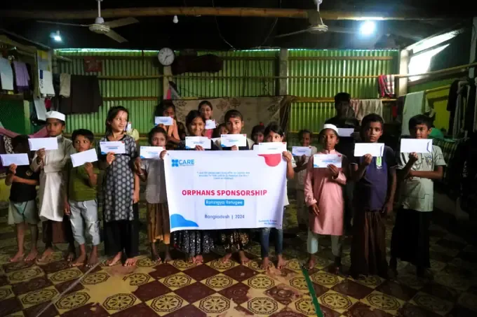 Children with certificates at a CBB orphan distribution