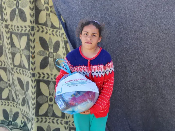 A girl receives a CBB relief pack