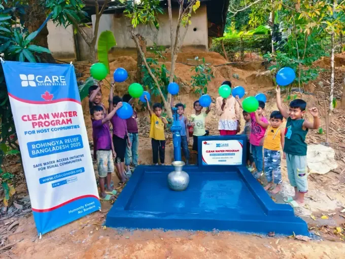 A boy drinks clean water with his hands at a CBB pump