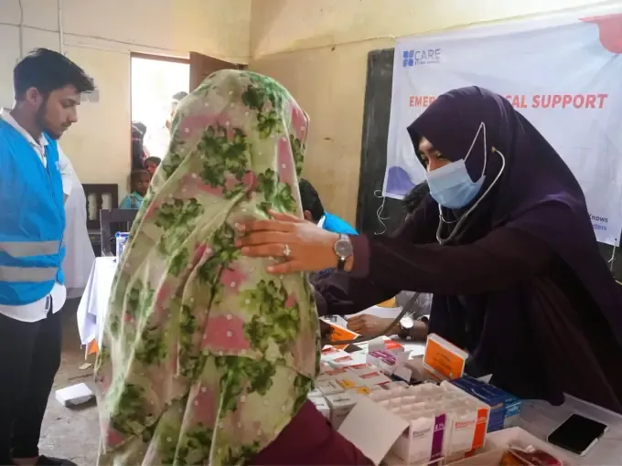 Aid handed to a woman at a CBB relief distribution