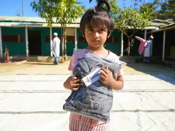 A boy receives a CBB winter clothes pack