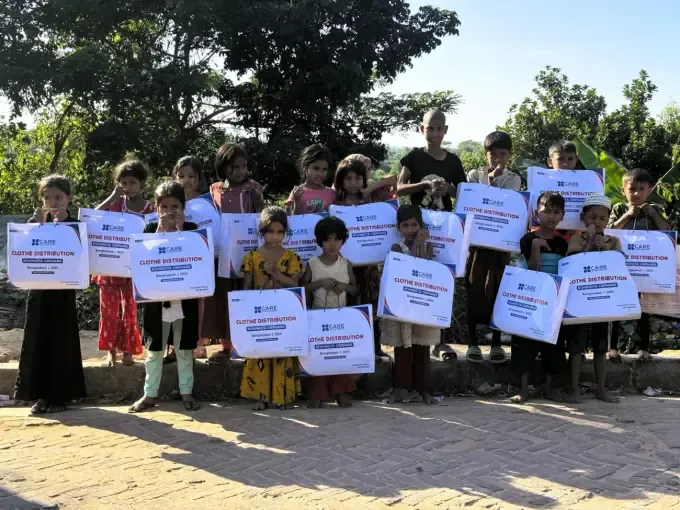 A CBB volunteer shares a meal with sponsored children