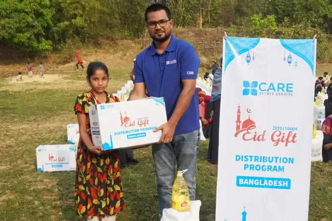 A man holds a CBB Eid Gift food pack box