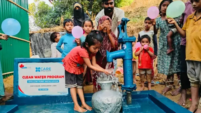 Children carry clean water home from a CBB pump
