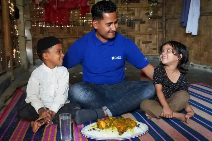 A CBB volunteer with a smiling sponsored girl