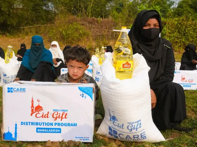 A boy with a CBB Eid Gift food pack and oil