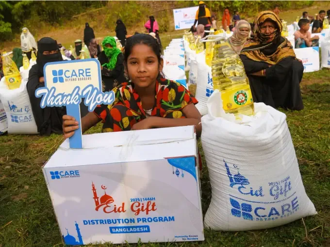 A woman holds a CBB Eid Gift food pack