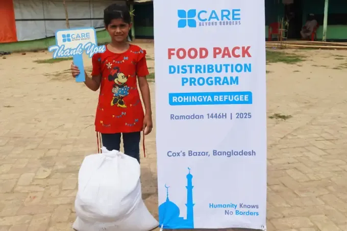 A boy carries his CBB food pack bag home