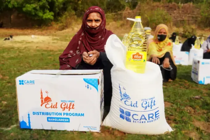 A woman receives CBB food staples and cooking oil