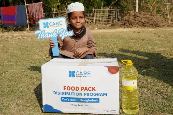 A boy with a CBB Eid Gift food pack box