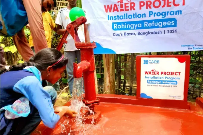 A child plays in the clean water from a CBB pump