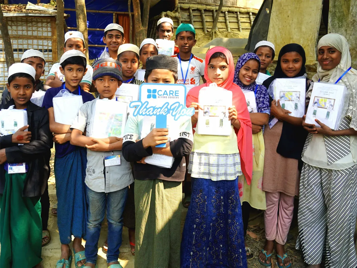 Children holding school notebooks from CBB Canada's education program