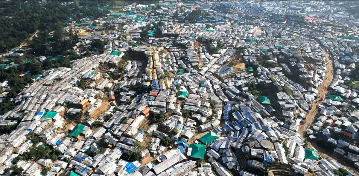 Bamboo-and-tarpaulin shelters stretching across the hills of Cox's Bazar